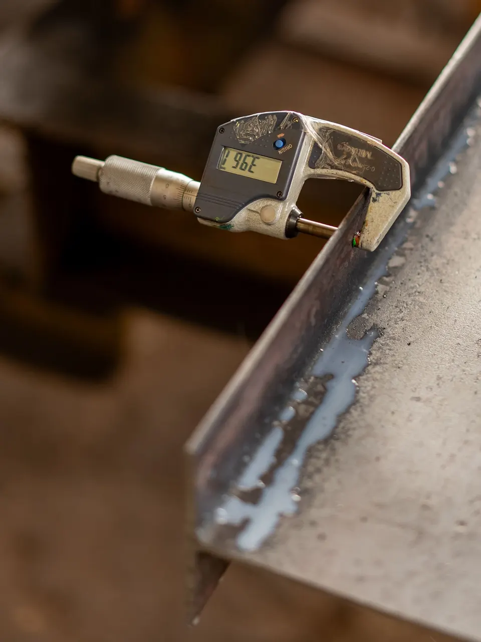 Micrometer measuring the thickness of a metal part